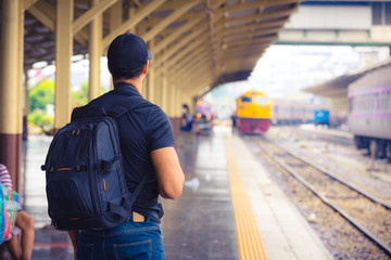 rear view of a man waiting for train in railway station