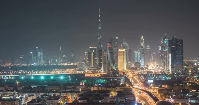 DUBAI, UAE – MARCH 2016 : Timelapse of downtown skyline at night with Burj Khalifa and traffic in view