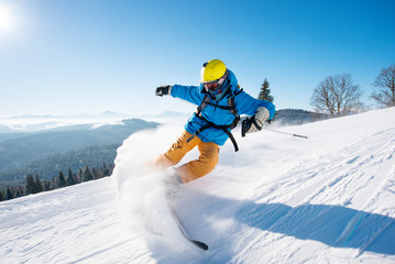 Shot of a professional skier riding the slope on a beautiful winter day copyspace ski resort...