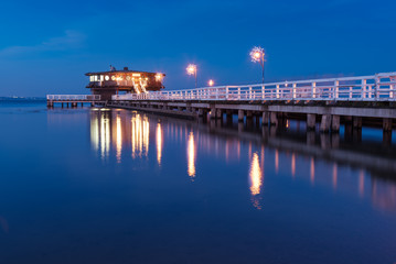 Plakat Illuminated pier in Puck at night. Baltic Sea, Poland.
