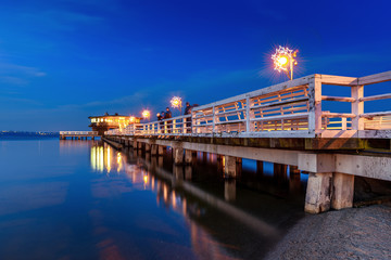 Illuminated pier in Puck at night. Baltic Sea, Poland.