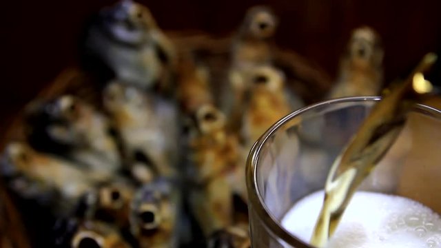 dry fish in a basket and beer