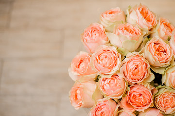 romantic bouquet of roses apricot color close up on white background