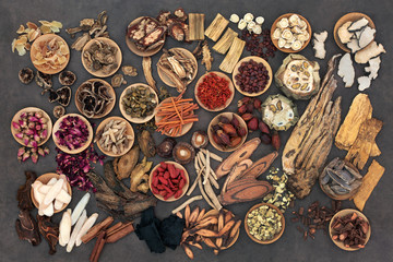 Large selection of traditional chinese herbs used in alternative herbal medicine in wooden bowls...