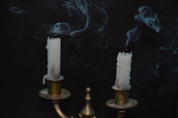 White candles on a black table