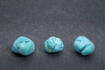 turquenite gemstone on slate stone