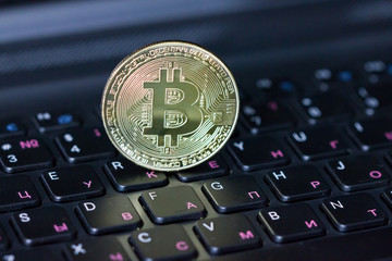 Golden bitcoin on keyboard, new virtual money.