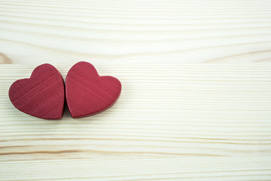 Two hearts on a wooden background