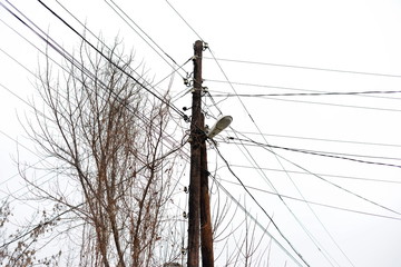 Chaos of cables and wires on electric pole, Messy wires attached to electrics pole in Bangkok,...