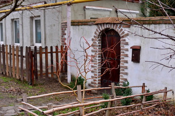 Fototapeta na wymiar Door entrance of residential house with rose flower and fence
