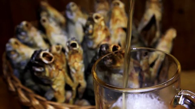 dry fish in a basket and beer