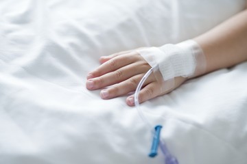 Person in hospital with cannula in hand