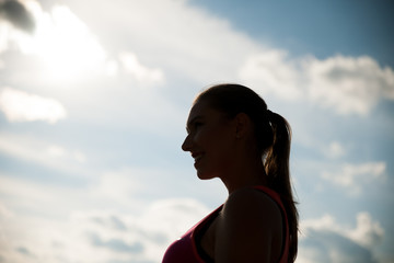 Silhouette of a beautiful young woman hiking the mountains