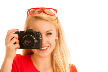 Woman in red with a retro camera isolated over white background