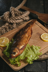 Fried fish on plate with vegetables