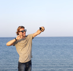 Teenage boy using smart phone.Selfie