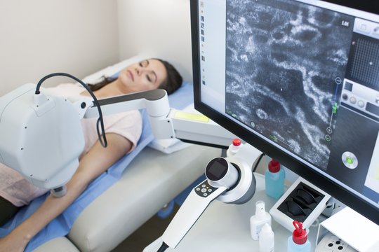 Patient on bed, computer screen in foreground