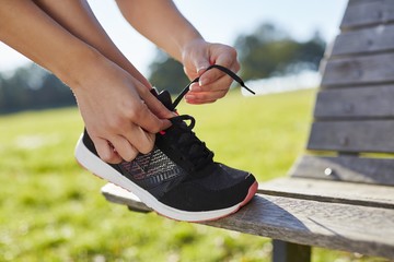 Woman tying up trainers