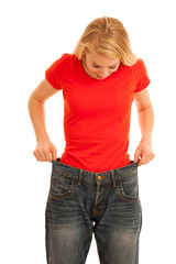 Fototapeta premium Woman wears too big trousers as she loose weight - weightloss
