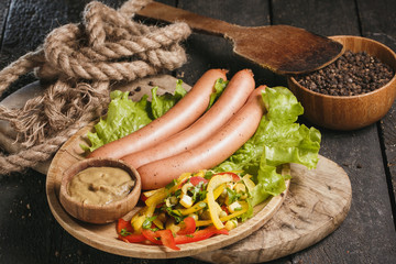 Sausage and vegetables on the wooden table