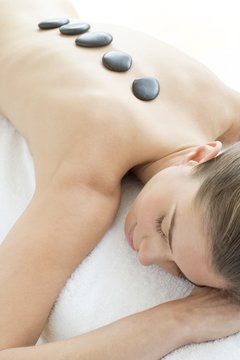 Woman relaxing with hot stones on back