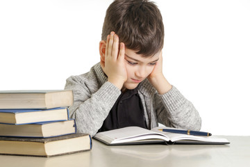 Studio portrait of young boy struggling with his homework - learning difficulties concept
