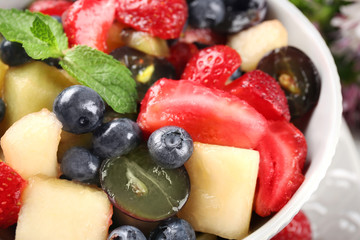 Bowl with delicious fruit salad, closeup