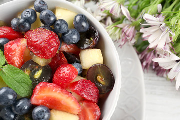Bowl with delicious fruit salad, closeup
