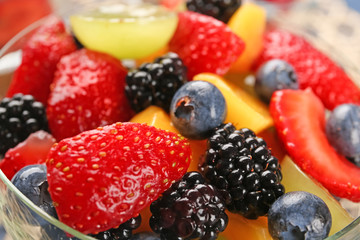 Bowl with delicious fruit salad, closeup