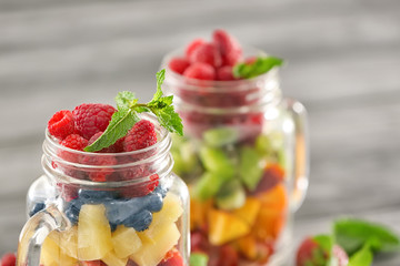 Mason jar with fruits and berries, closeup