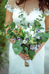 bride with wedding bouquet. Morning at wedding day at summer. Beautiful mix white violet peonies and eustoma