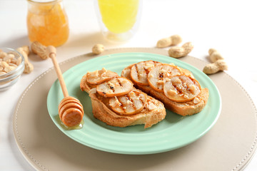 Plate with tasty sweet toasts on table