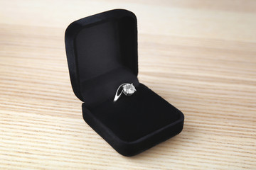 Beautiful engagement ring in box on table