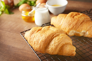 Fresh yummy croissants on wooden table