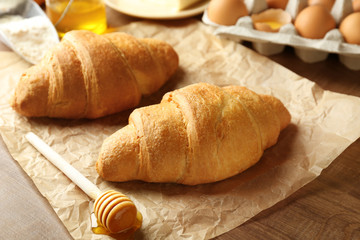 Fresh yummy croissants on wooden table