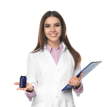 Young Female Pharmacist With Medicament And Clipboard On White Background