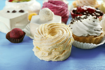 Assortment of tasty sweets on wooden background, closeup
