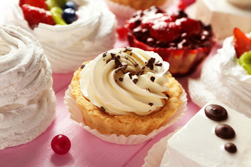 Assortment of tasty sweets on wooden background, closeup