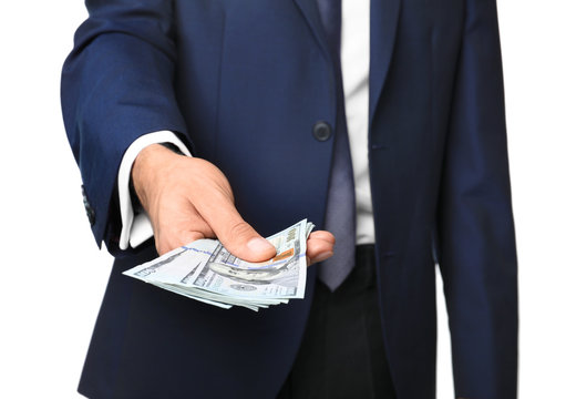 Businessman holding money on white background. Corruption concept