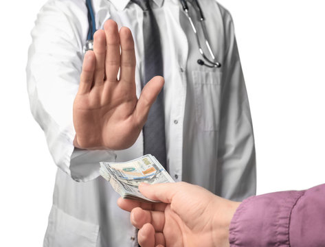 Doctor refusing to take money from man on white background. Corruption concept