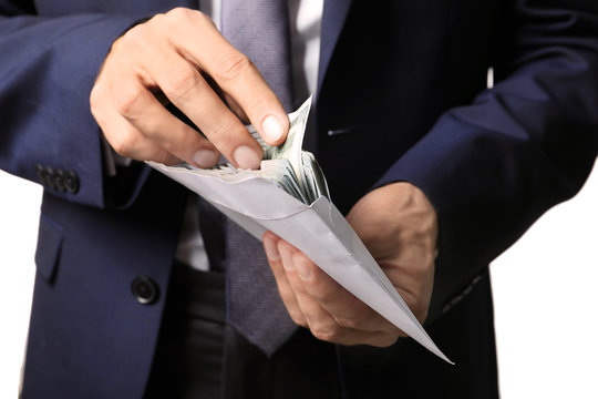 Businessman holding envelope with money. Corruption concept