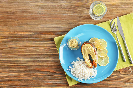 Tasty Rainbow Trout Steak With Garnish And Sauce On Plate, Top View