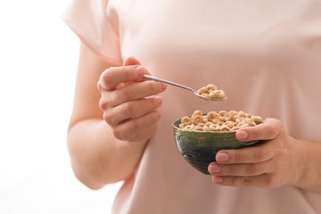 Closeup of woman's hands holding bowl with organic whole wheat cereal. Healthy Breakfast or snack. Healthy food and eating.