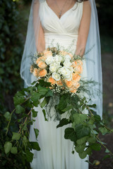 bride with wedding bouquet. Morning at wedding day at summer. Beautiful roses