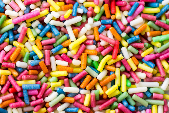 Closeup of a pile of colourful sugar sprinkles (cake decor), from above