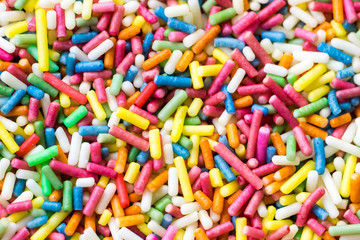 Fototapeta na wymiar Closeup of a pile of colourful sugar sprinkles (cake decor), from above