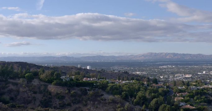 Locked off time lapse shot looking across the San Fernando Valley in Los Angeles, California. Parts of Van Nuys visible with mountains in the distance. 4K.
