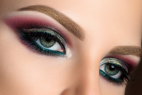 Close up of green woman eyes with fashion makeup