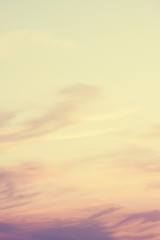 The vertical view of sky background or texture at the sunset time with clouds. Copy space