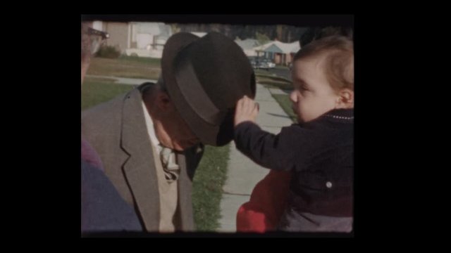 1960 Grandfather teasing baby grandson